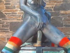 Sexy chick with body ink riding huge dildo